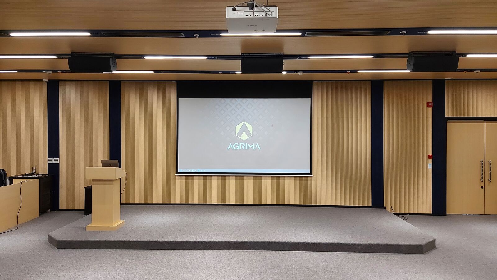 Balaji Wafers auditorium stage, podium, and projection screen