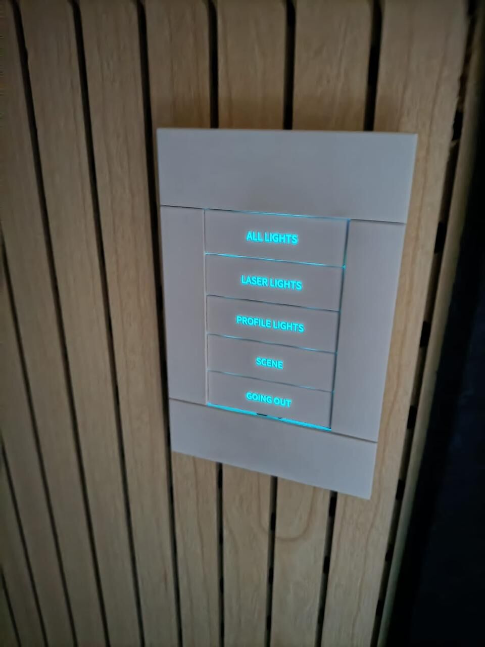 Wall-mounted lighting and AV control keypad at Balaji Wafers auditorium, labeled All Lights, Laser Lights, Profile Lights, Scene, and Going Out