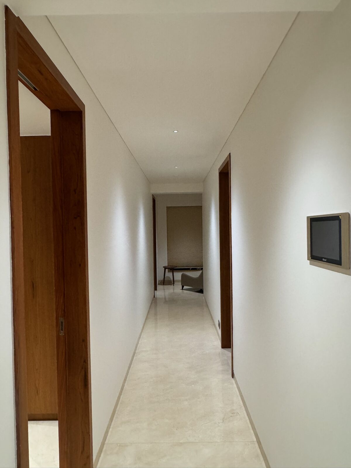 J. Bhalodia Residence corridor with wall-mounted control touchpanel