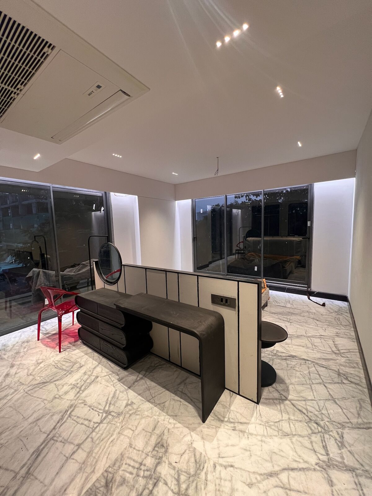 Emberlynn study nook with sculptural desk and marble flooring