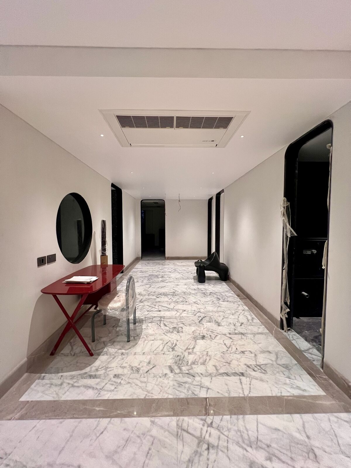 Emberlynn hallway with marble flooring and accent furniture