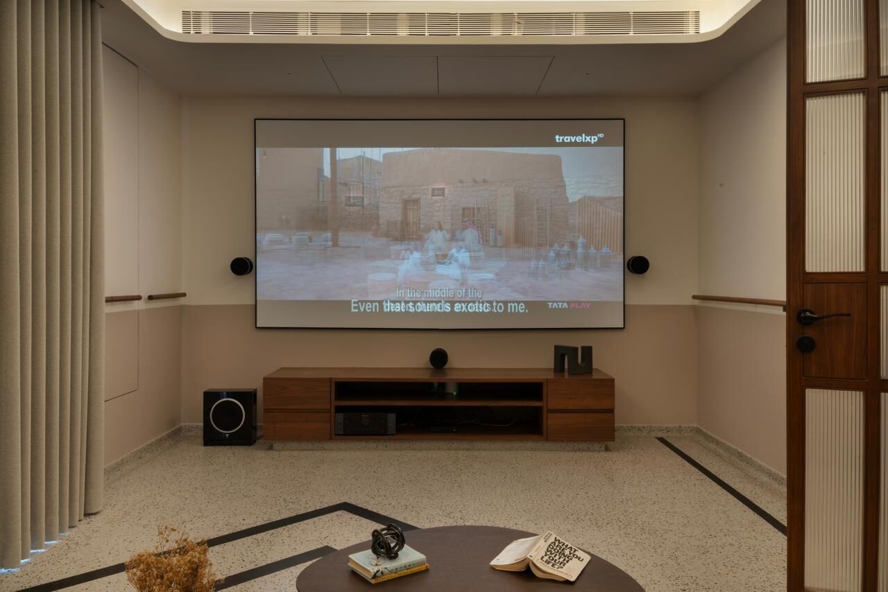 Mayur Gajera residence home theater with projector screen and surround sound