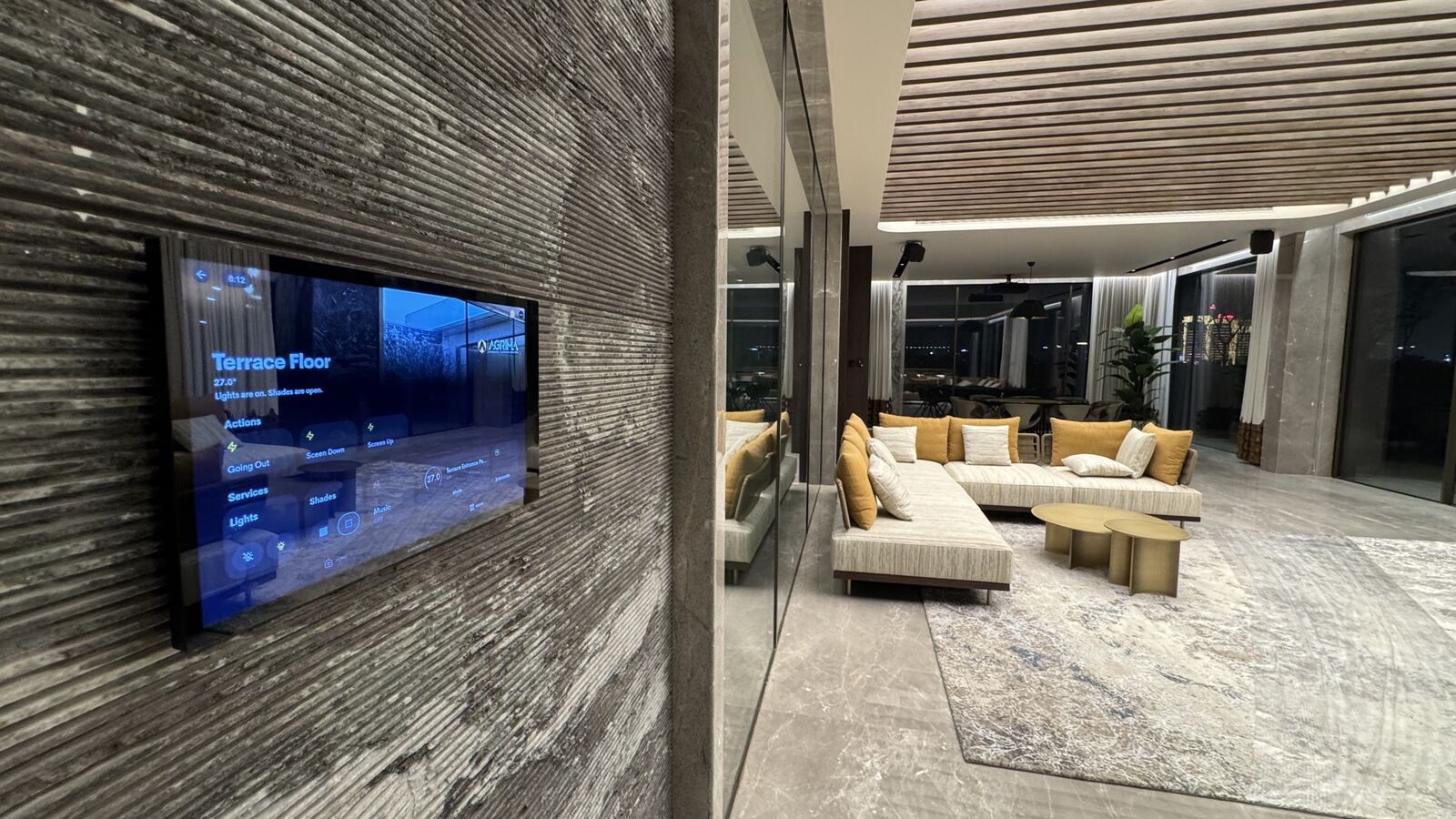 Living area with wall-mounted display and integrated lighting at the Rohan Kataria residence